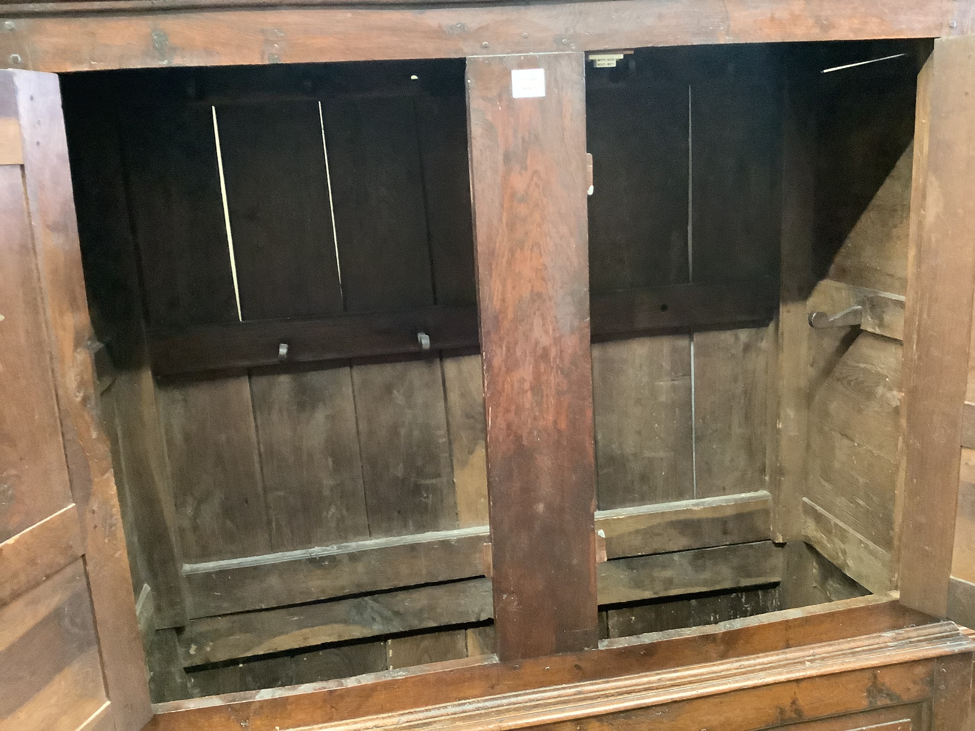 An 18th century panelled oak bacon cupboard